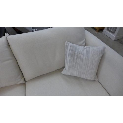 1438 - A designer cream upholstered two seat sofa (slightly marked)