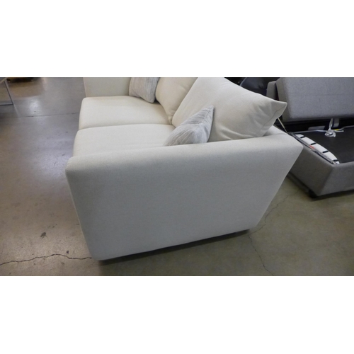 1438 - A designer cream upholstered two seat sofa (slightly marked)