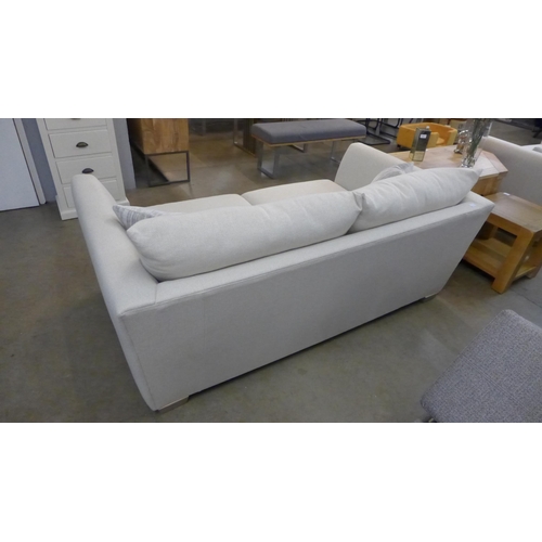 1438 - A designer cream upholstered two seat sofa (slightly marked)