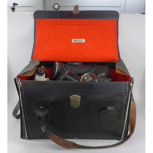 688 - A leather camera bag containing a Praktica Super TL 35mm film camera and equipment including Prinzga... 