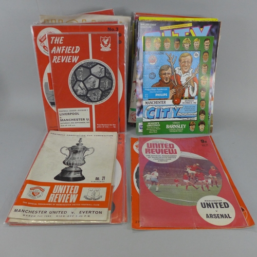 691 - A box of 1960's and 1970's Manchester United football programmes, etc.