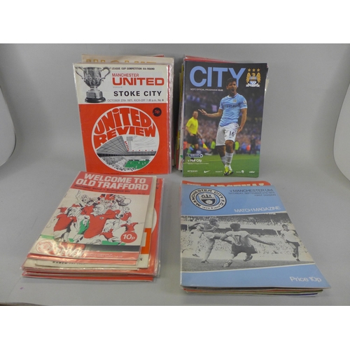 691 - A box of 1960's and 1970's Manchester United football programmes, etc.