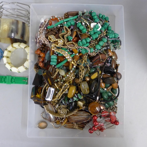 694 - A collection of costume jewellery including beaded necklaces, bangles, etc.