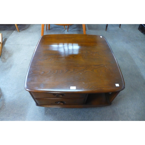 104 - An Ercol Golden Dawn elm Pandora's box coffee table