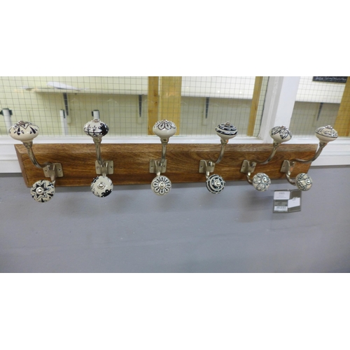 1357 - A rack of six coat hooks with ceramic knobs (HH565424)   #