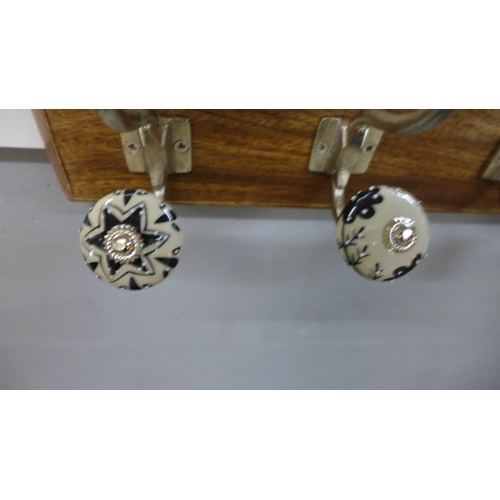 1357 - A rack of six coat hooks with ceramic knobs (HH565424)   #