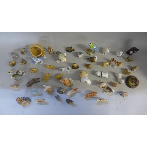 678 - A collection of Wade Whimsies, a Beswick Blue-tit and other small figures