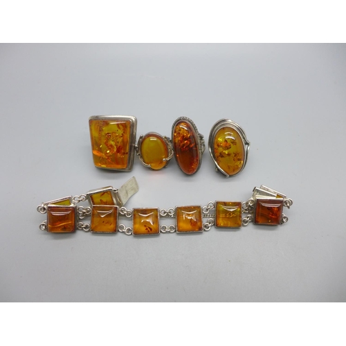 953 - Four silver and amber rings and a silver and amber bracelet, (three rings and the bracelet with impo... 