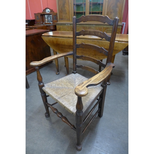 34 - A set of six George III style elm rush seated ladderback chairs