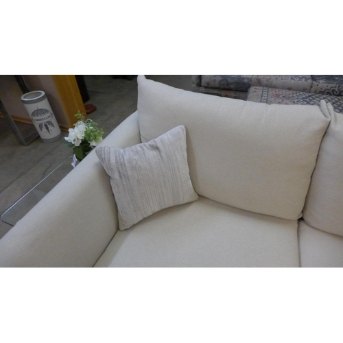 1395 - A designer cream upholstered two seat sofa (slightly marked)