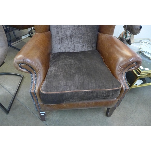 1338 - A brown leather and velvet wingback armchair