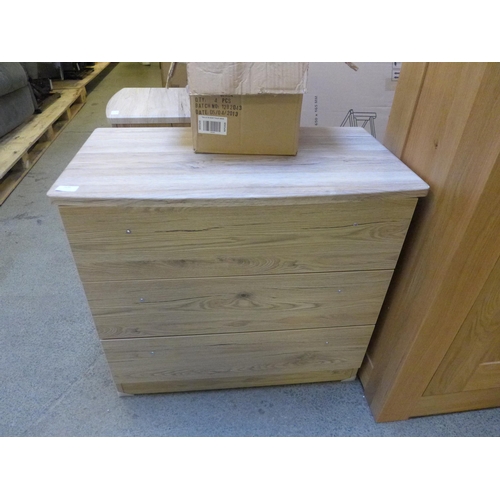1636 - An ash effect chest of three drawers * This lot is subject to VAT
