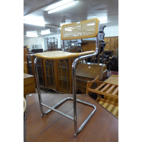 101 - An Italian chrome, beech and wicker cantilever stool, designed by Marcel Breuer