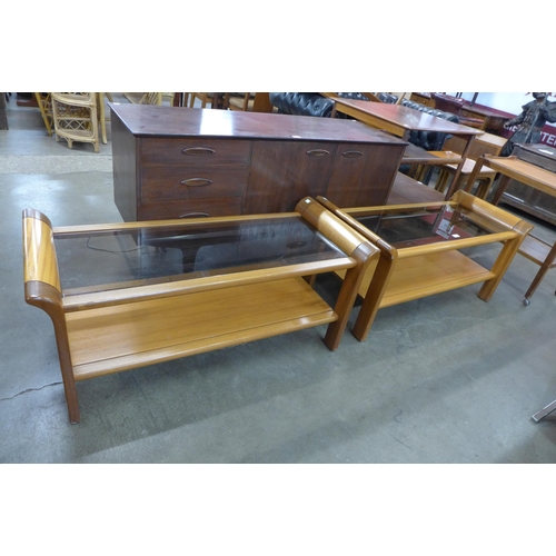 112 - A pair of teak and glass topped coffee tables