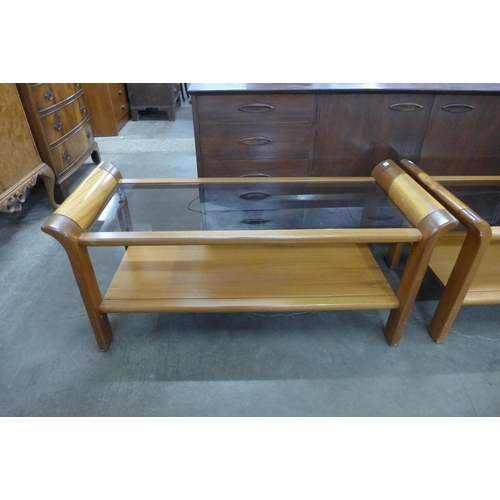 112 - A pair of teak and glass topped coffee tables