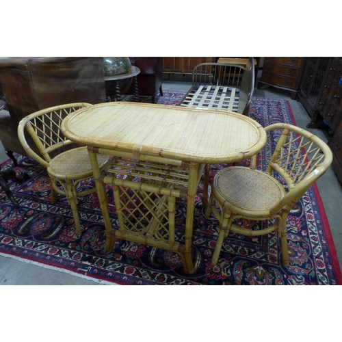 115 - A rattan and bamboo table and two chairs