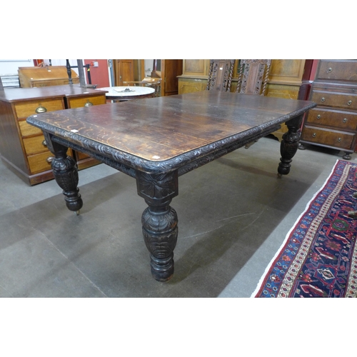 36 - A Victorian carved oak extending dining table