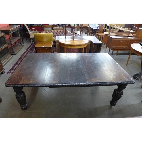 36 - A Victorian carved oak extending dining table