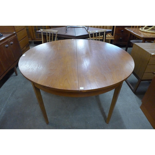 87 - A teak extending dining table