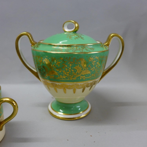744 - An Aynsley green, gold and white part coffee set comprising five cups, six saucers, cream and sugar ... 