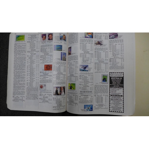 773 - A collection of world stamps in three albums and two stamp catalogues