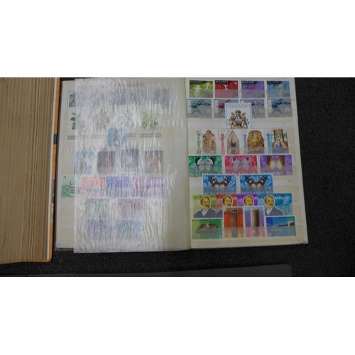 773 - A collection of world stamps in three albums and two stamp catalogues