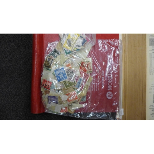 773 - A collection of world stamps in three albums and two stamp catalogues