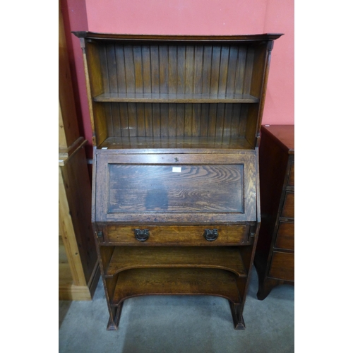 26 - An Arts and Crafts oak bureau bookcase