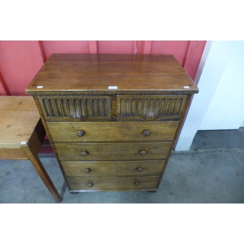 3 - A Nigel Griffiths carved oak chest of drawers