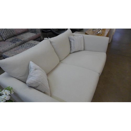 1389 - A designer cream upholstered two seater sofa (slightly marked)