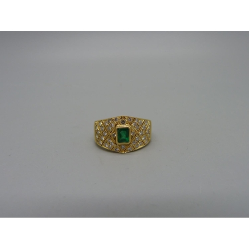 1006 - An 18ct gold, diamond and emerald ring, 5.3g, M, width of top 11mm