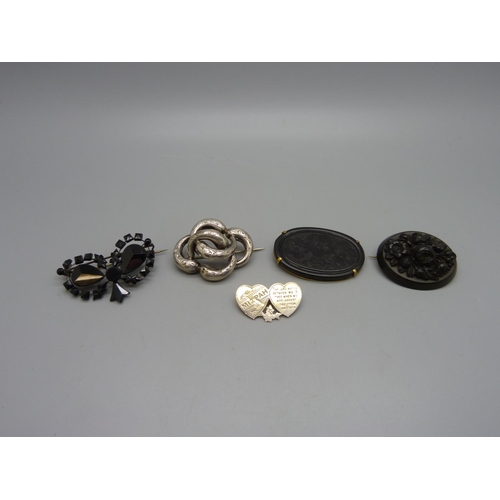 1018 - A Victorian carved jet brooch, a French jet brooch, a silver Mizpah brooch and two others