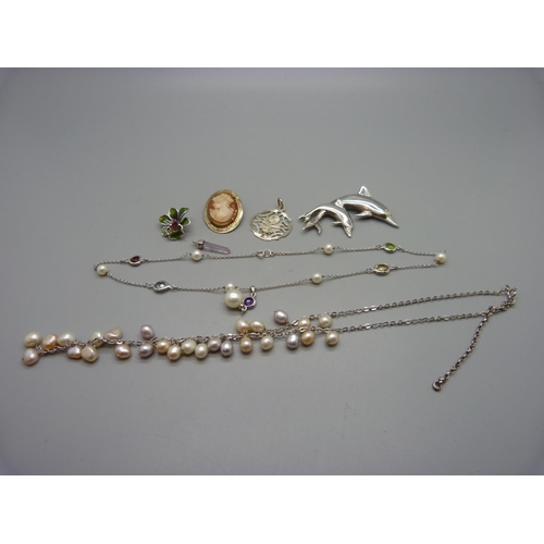 1034 - A 925 silver dolphin brooch, two necklaces, a silver and enamel flower pendant, etc.