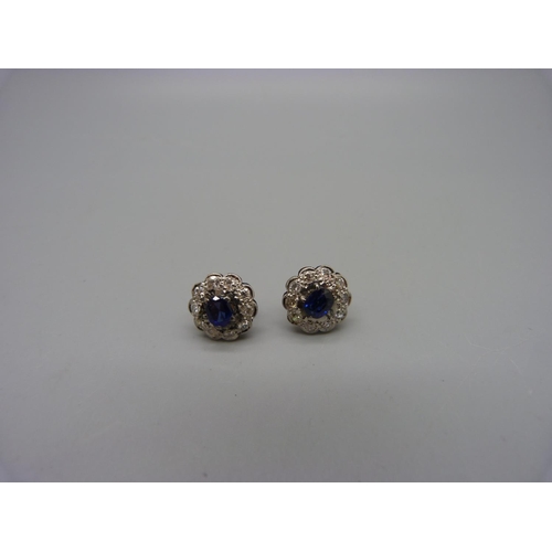 1058 - A pair of sapphire and diamond cluster earrings, 7mm