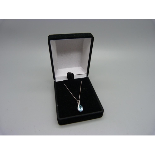 1060 - A 9ct white gold and topaz pendant and chain, 2.3g