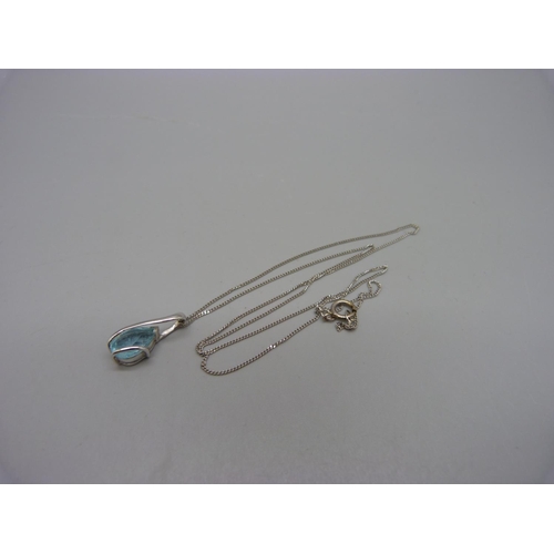 1060 - A 9ct white gold and topaz pendant and chain, 2.3g