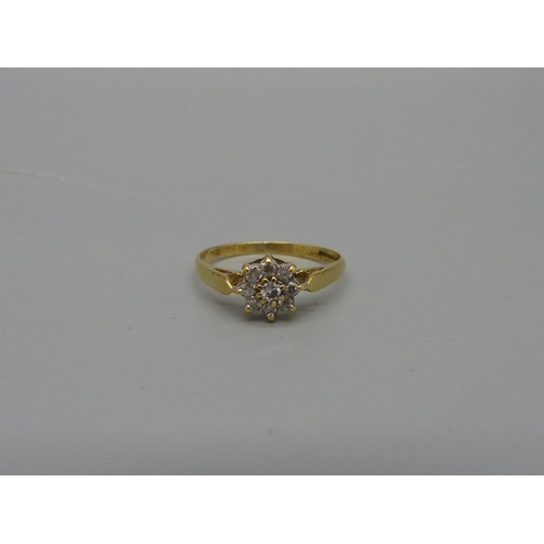 1066 - An 18ct gold, nine stone diamond cluster ring, 2.2g, O