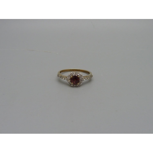 1072 - A 9ct gold, garnet and white stone ring, 1.8g, P