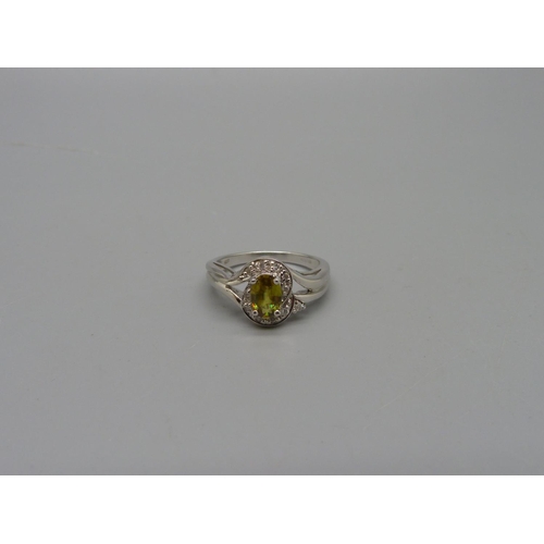 1074 - A 9ct white gold, eleven diamond and sphene set ring, 3.5g, N