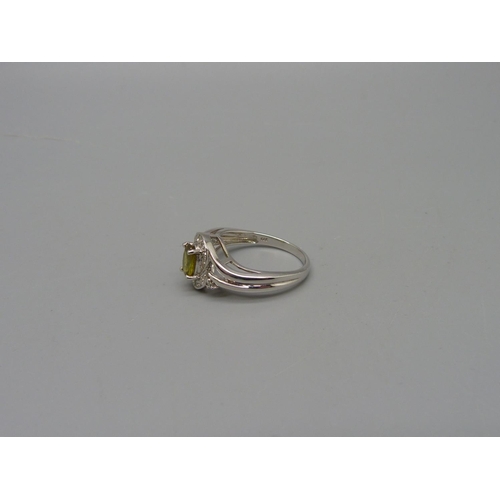 1074 - A 9ct white gold, eleven diamond and sphene set ring, 3.5g, N