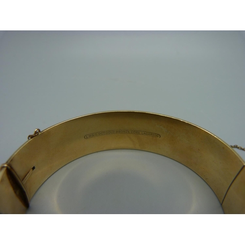 1078 - Two 9ct gold bronze core bangles, one with inscription