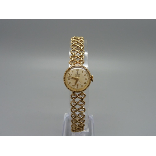 1100 - A lady's 9ct gold Tudor Royal wristwatch on a 9ct gold bracelet strap marked Rolex, total weight 21.... 