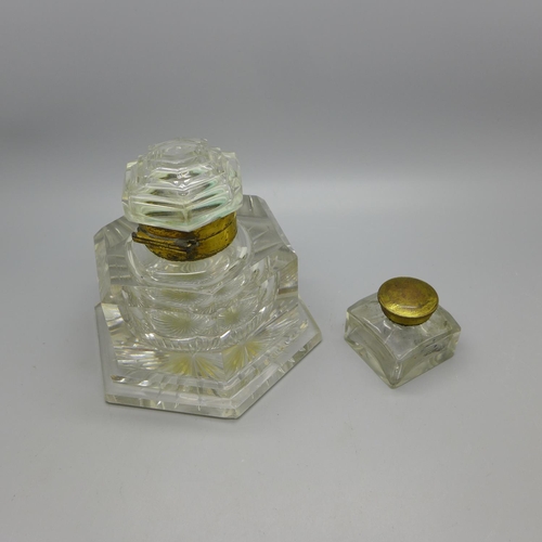 624 - A heavy cut glass inkwell and a smaller glass ink bottle