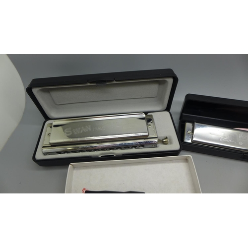 629 - Three harmonicas including Swan Performance harmonica 24 and chromatic 12-48 harmonica and a tin whi... 