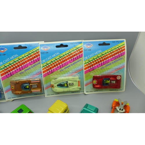 634 - Six Tins' Toys model vehicles in packets and other loose Matchbox model vehicles