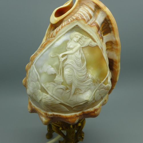 639 - A carved shell cameo table lamp on a gilt metal base, 23cm