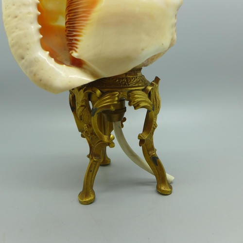 639 - A carved shell cameo table lamp on a gilt metal base, 23cm