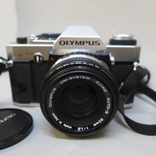 730 - Cameras and accessories including an Olympus OM20 body, a Polaroid and a miniature novelty camera