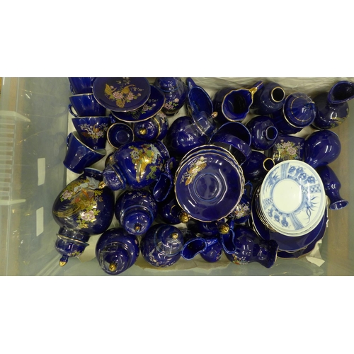 810 - Fifty-eight pieces of cobalt blue Japanese porcelain including a coffee set, vases and pots