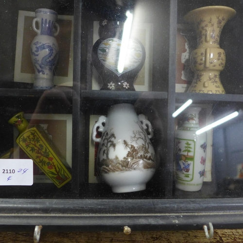 817 - Oriental style miniature vases in a display case